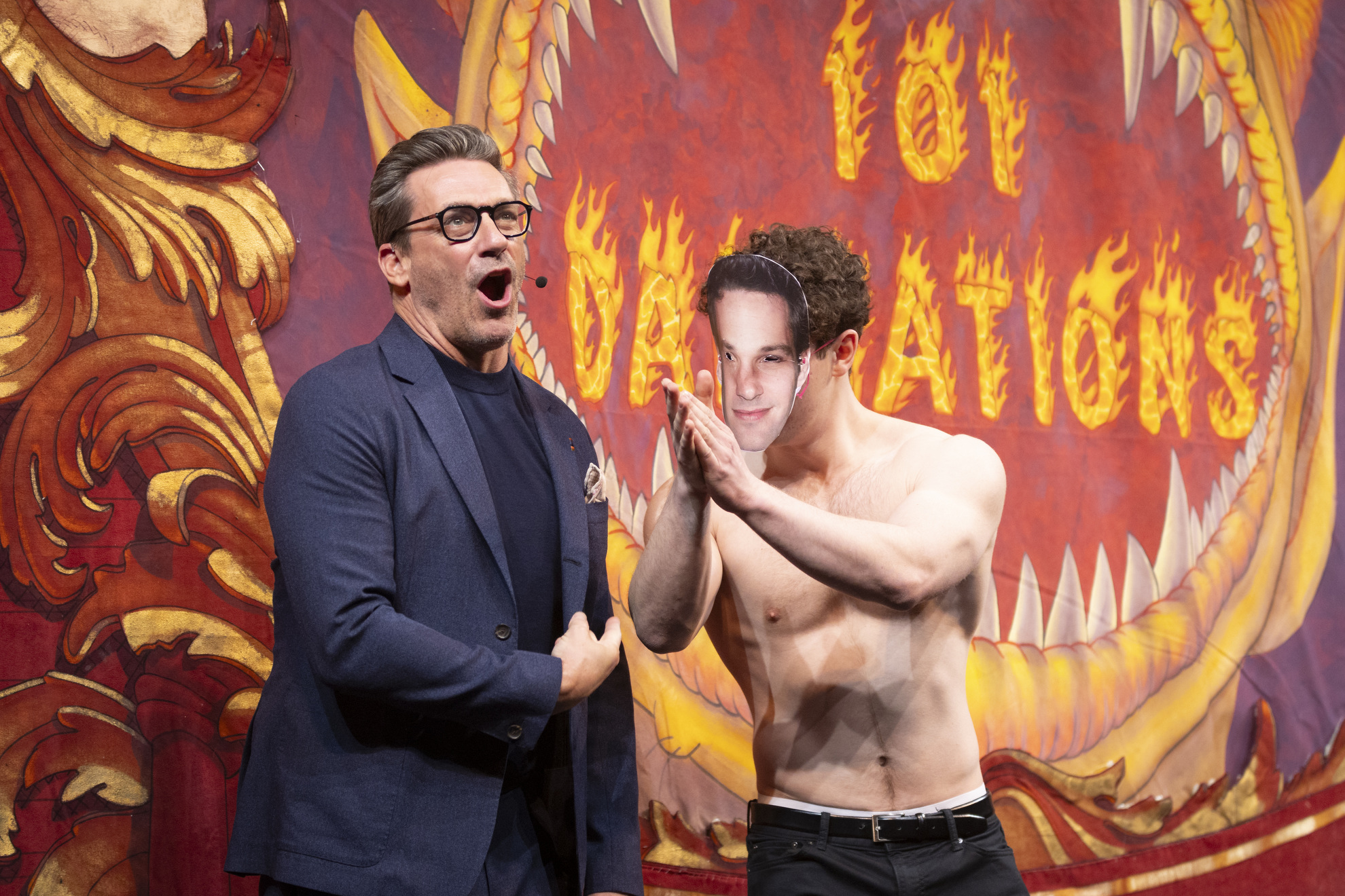 Jon Hamm flexes his bicep next to Roast character, “The Real Paul Rudd,” played by junior Wes Lewin.