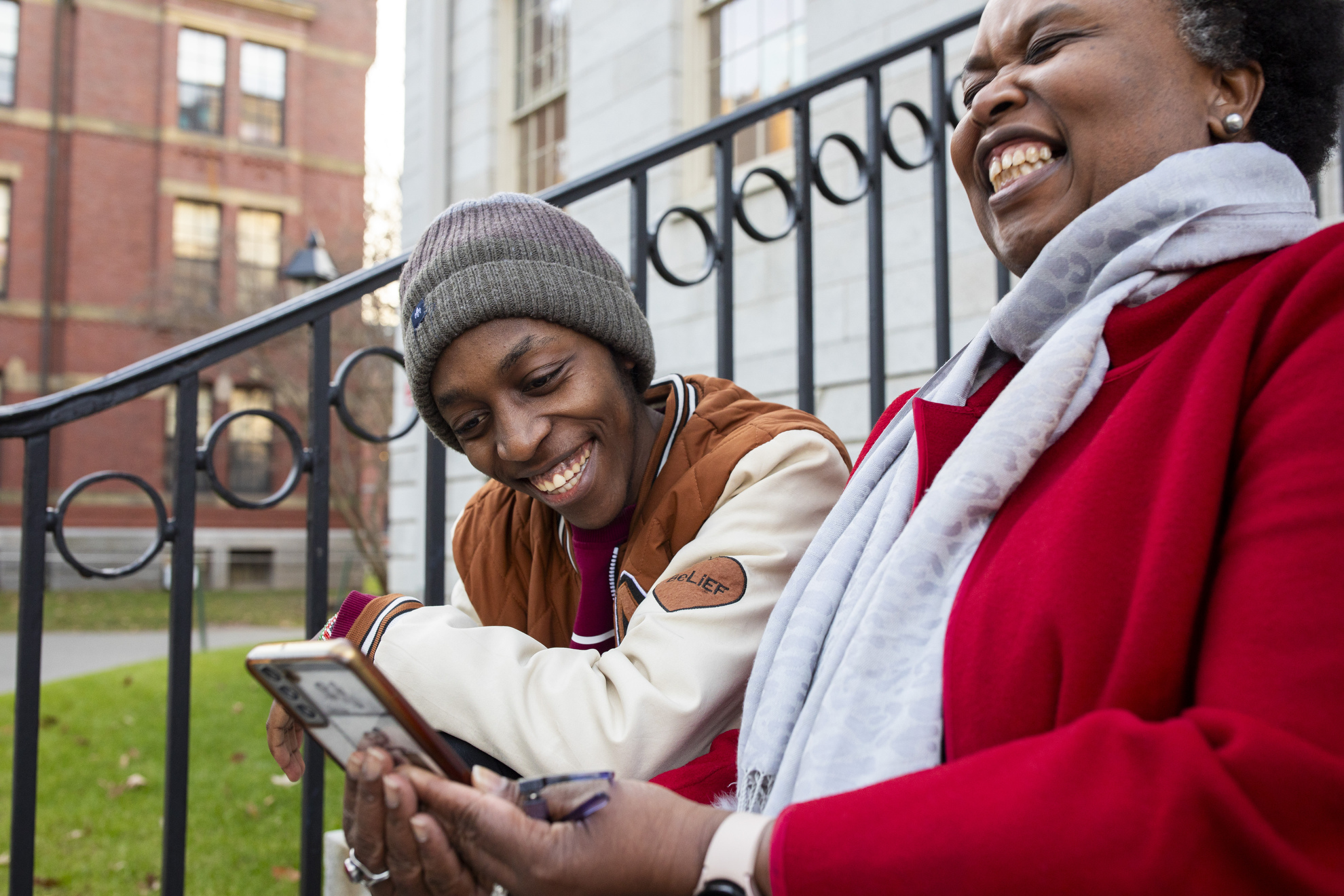 Emmanuel Enan Gachogu Muriuki (left), a first-year student, and Sheila Thimba share a laugh while browsing a phone