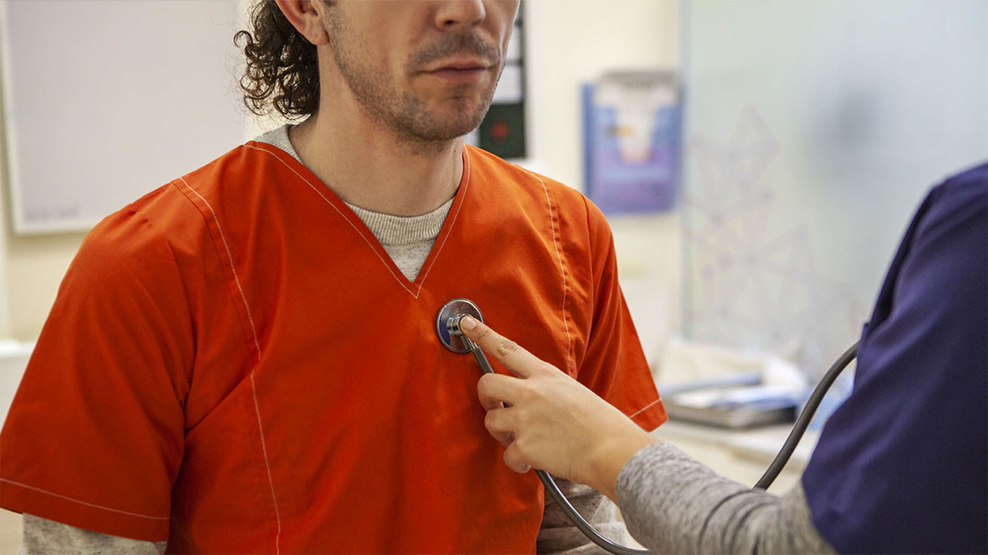 Picture of a detained individual being assessed by a medical expert.