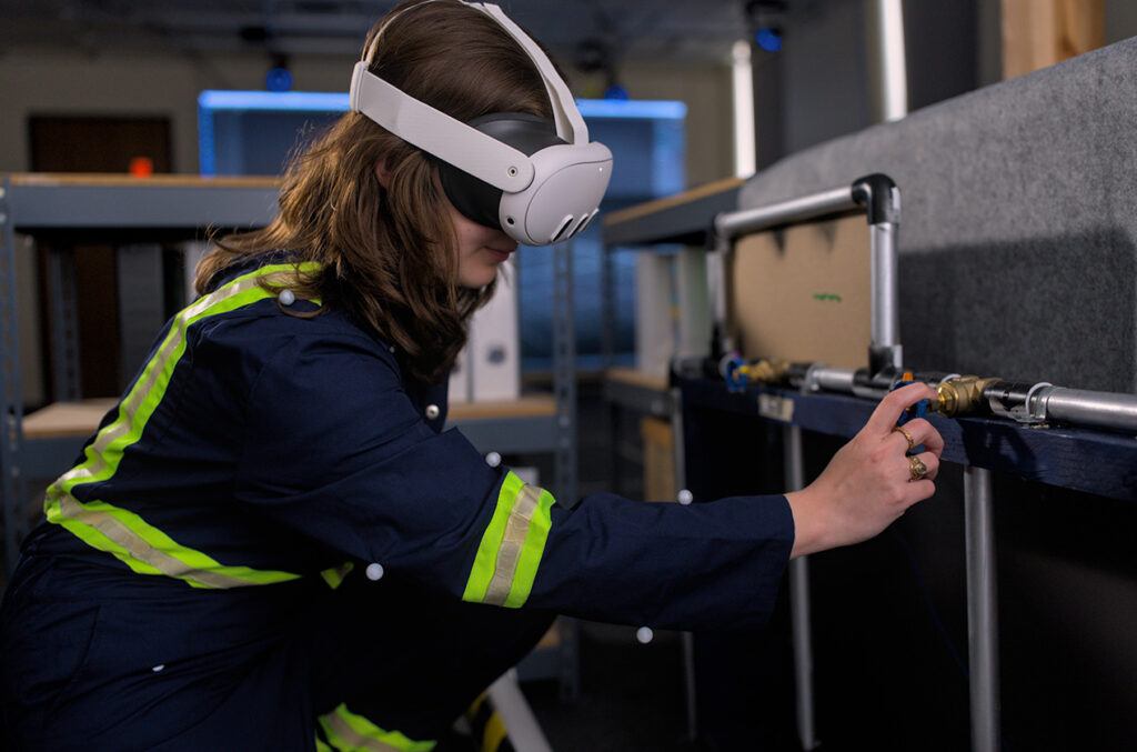 A woman is seen utilizing a virtual reality headset while engaging in activities in a lab environment.