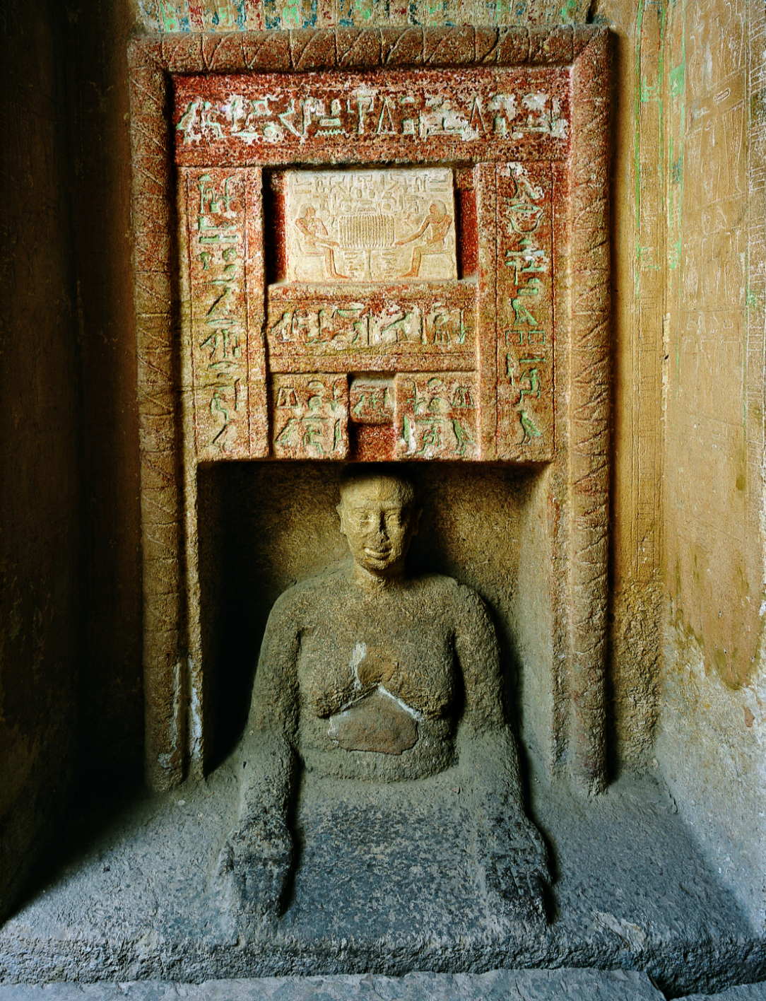 Photo of the statue of Idu emerging from the “false door.”