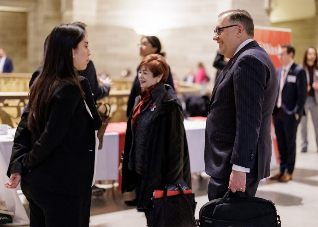 WashU student Jahselyn Medina (left), Trustee Maxine Clark (center), Chancellor Andrew Martin (right) and other WashU Advocates gather in the Missouri capitol, Feb. 5, 2025. (Photo: Whitney Curtis/WashU)