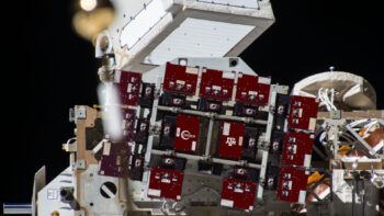 An illustrative graphic of the TAMU-SPIRIT connected to an EXPRESS Logistics Carrier on the exterior of the International Space Station. Individual scientific carriers are depicted in maroon.