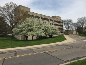 The University of Michigan Transportation Research Institute's four-story headquarters building is situated just off a roadway in Ann Arbor.