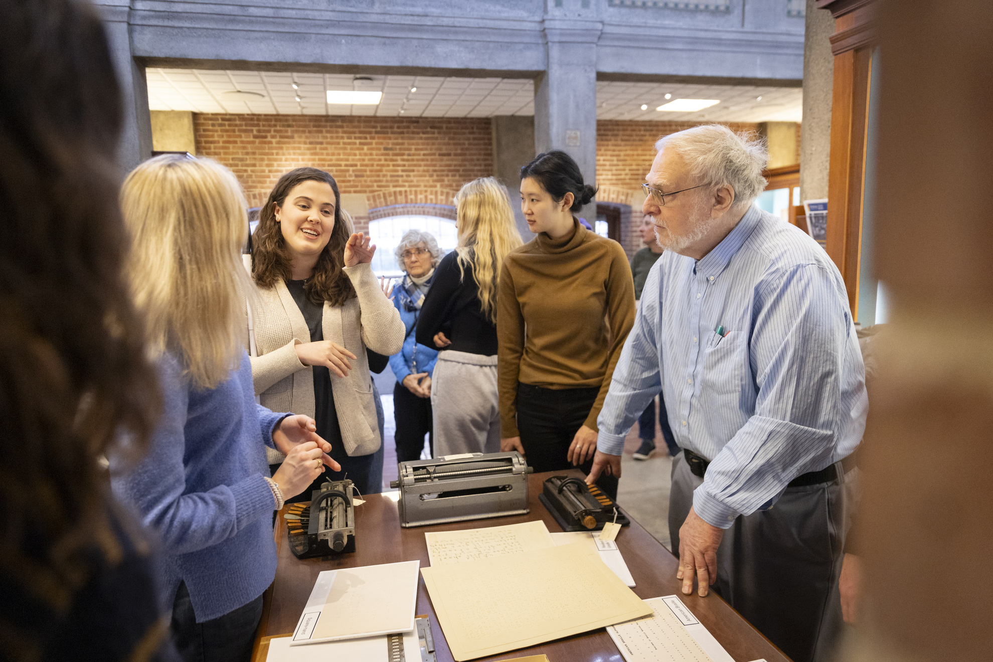 Katie Sevier '25 (left) and Marc Shell (far right) engage in conversation during the outing.