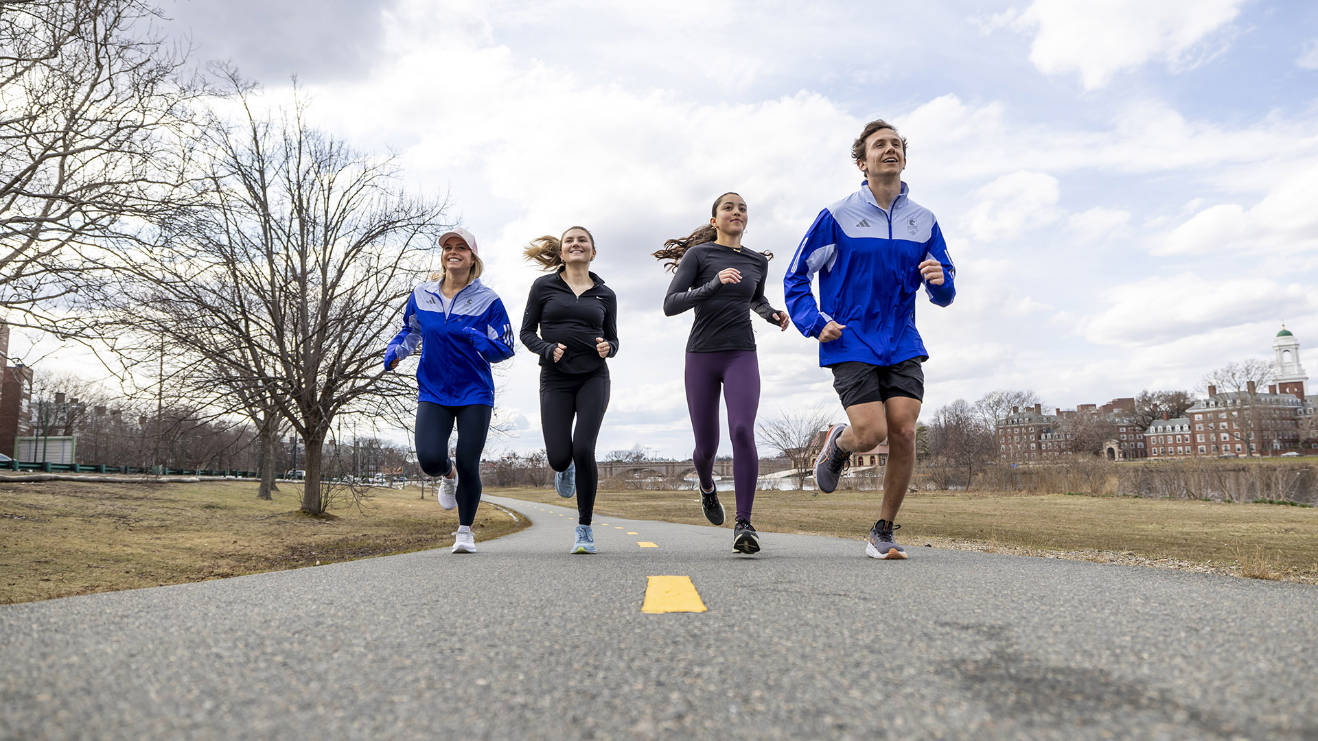 Bridget Kondrat, Maggie Chiappetta-Uberti, Brooke Stanford, and Andrew Athanasian jog along the Charles River.