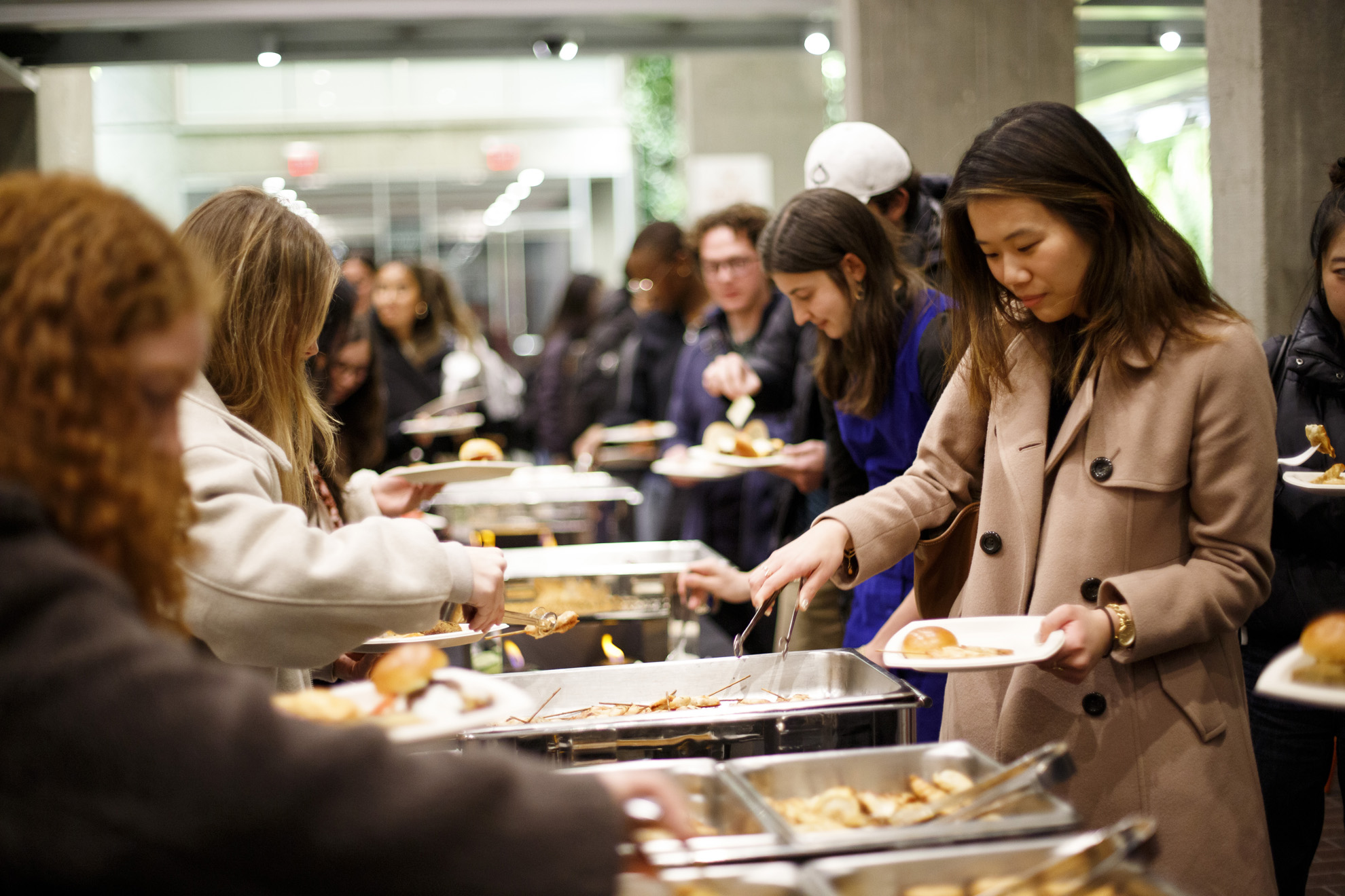 Students congregate in the lobby of the Smith Campus Center to share food.