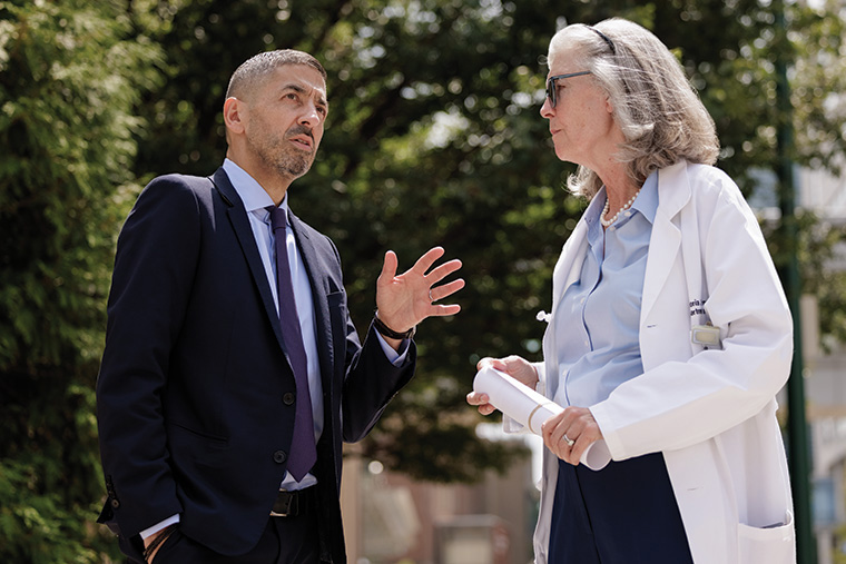 Since its inception in 2022, Here and Next has taken significant steps, prominently featuring the establishment of the School of Public Health and the addition of Dean Sandro Galea, MD, Dr.PH. In this image, he converses with Victoria Fraser, MD, the Adolphus Busch Professor of Medicine.