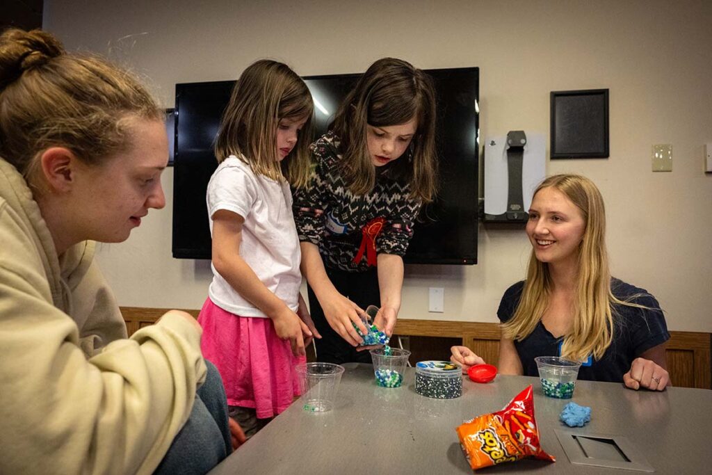 children play together with college students