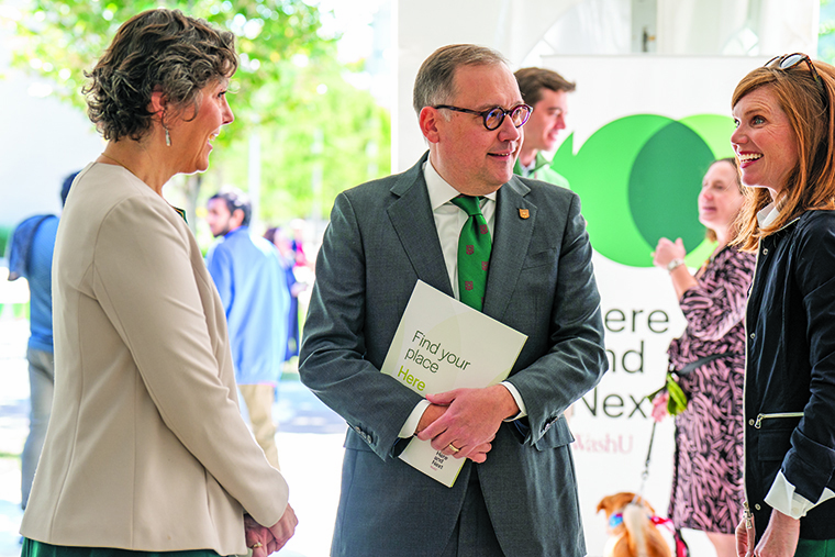 Provost Beverly Wendland engages with Chancellor Andrew Martin and Rebecca Brown, vice chancellor for strategic initiatives and university governance at a Here and Next launch event in 2022.