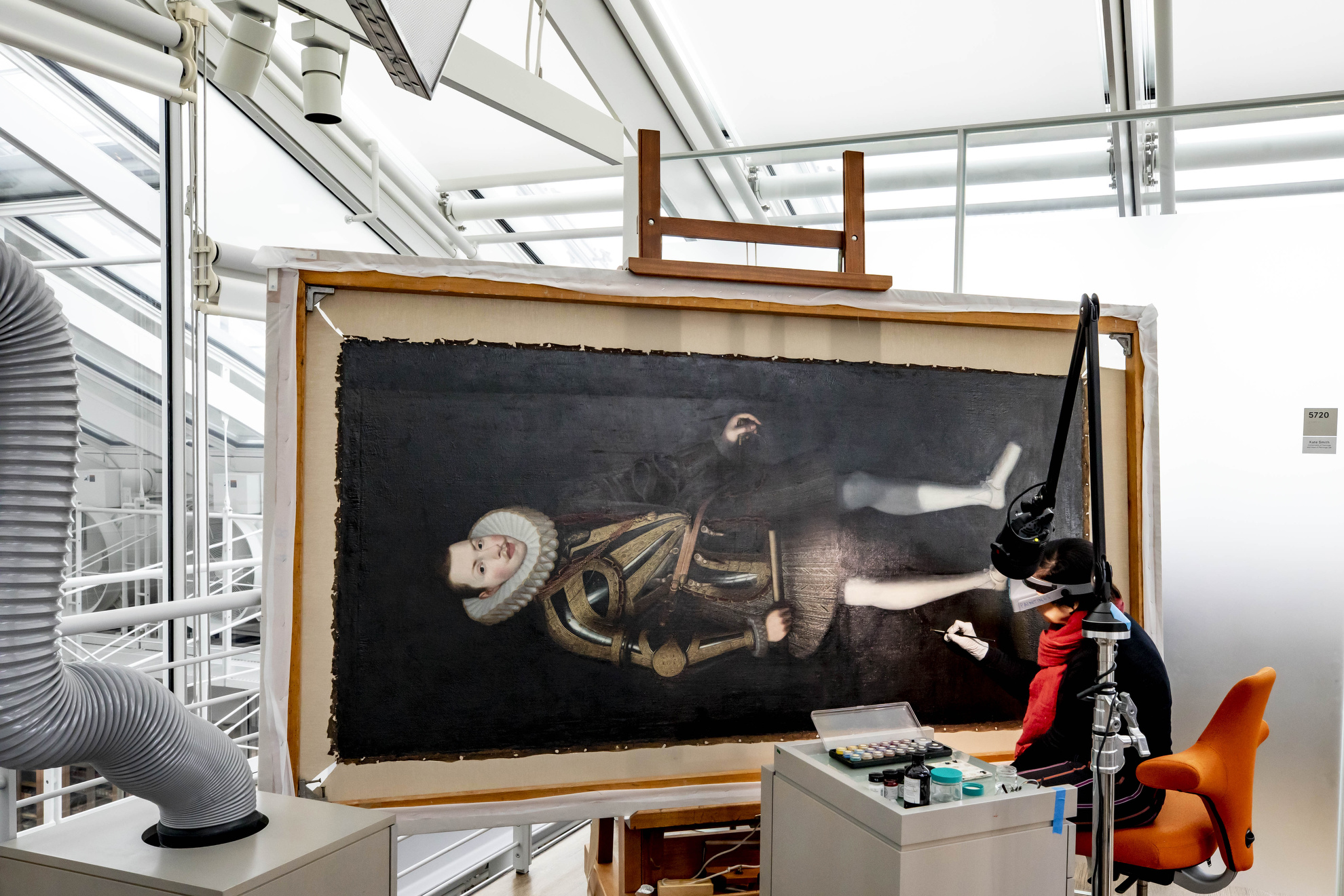 Cristina Morilla, Associate Paintings Conservator, restores a portrait of King Philip of Spain at the Harvard Art Museum.
