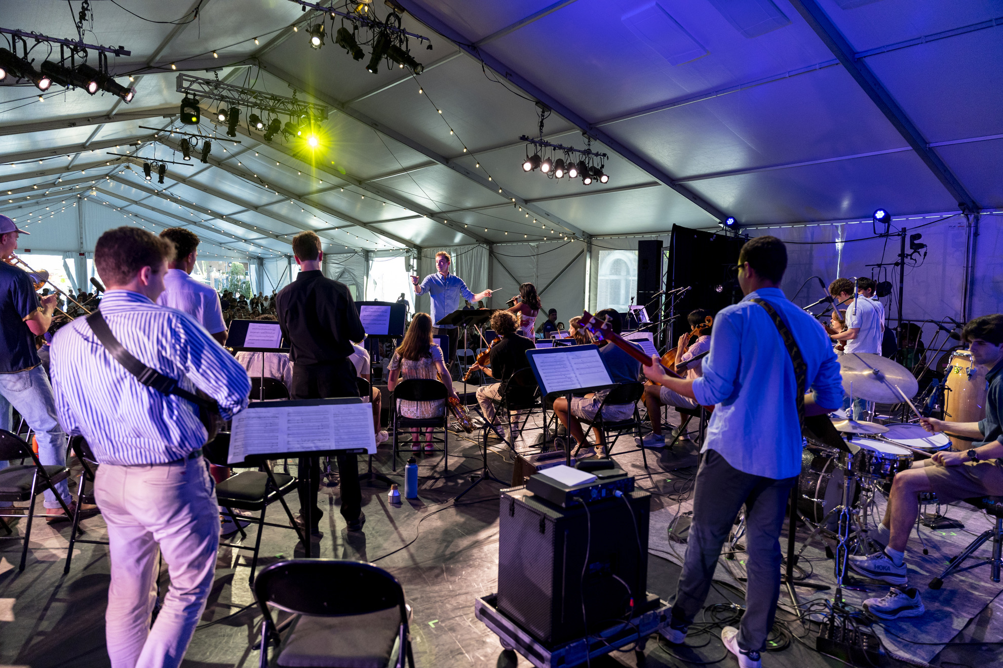 Emil Massad ’25 directs the Charles Revival and Friends performance at the Science Center Plaza tent.