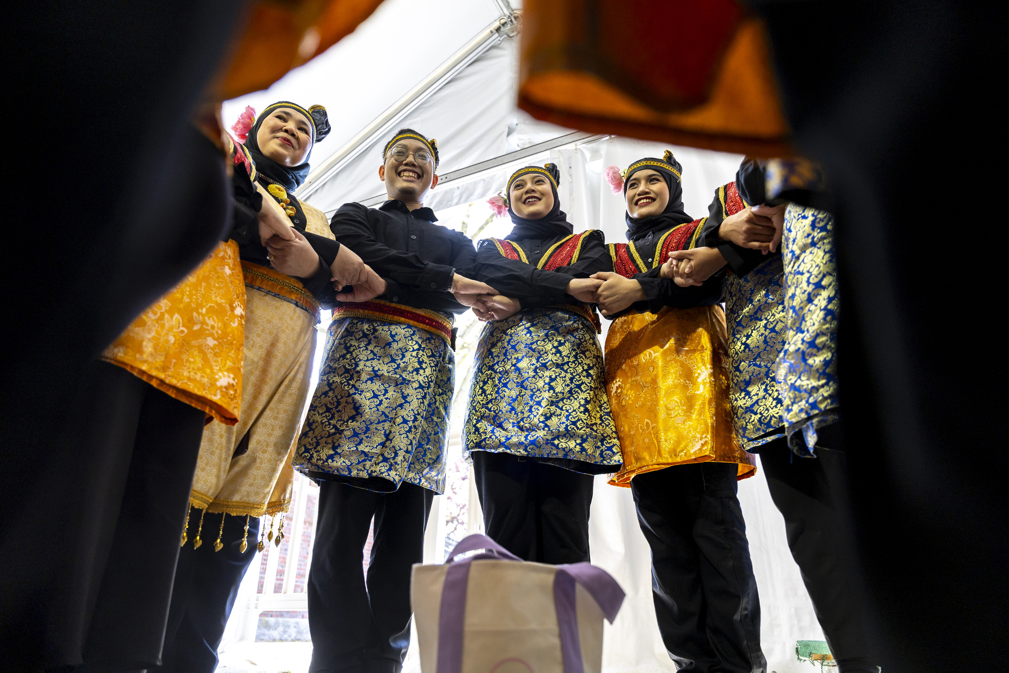 Members of the Boston Cendrawasih gather before their performance at the Science Center Plaza Tent.