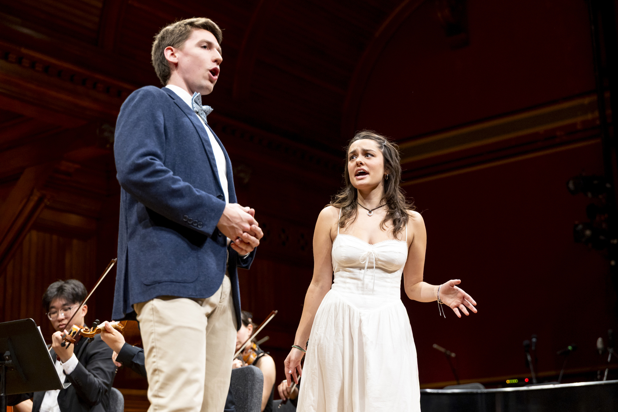 Joshua Halberstadt ’25 (left) and Ava Maha ’28 (right) present the Act 1 Finale from Mozart’s Don Giovanni during the Harvard College Opera’s concert at Sanders Theatre.