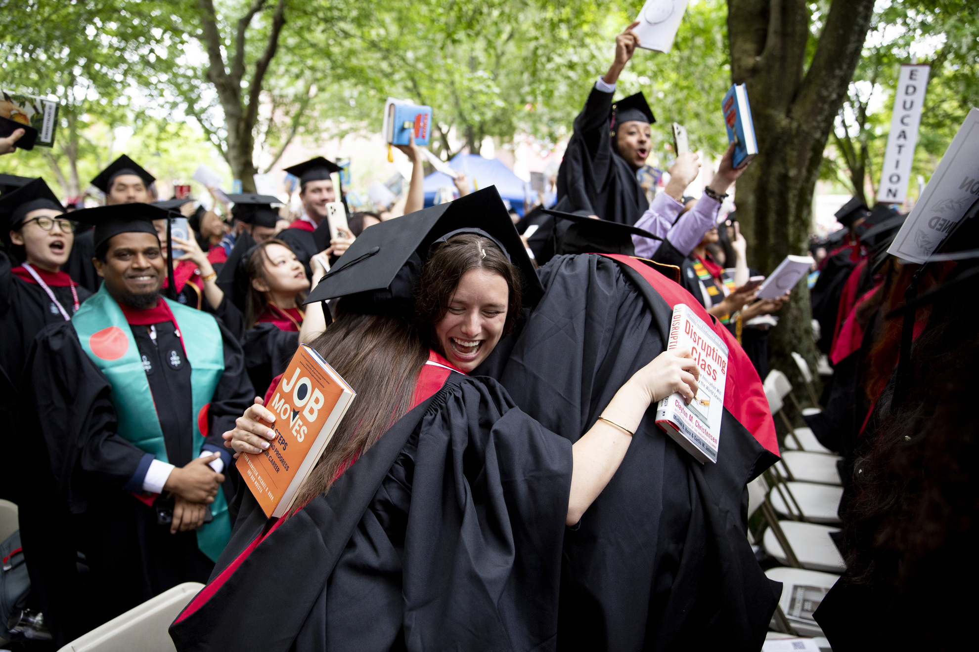 Makena Tenpenny (center) embraces her fellow Harvard Graduate School of Education classmates.