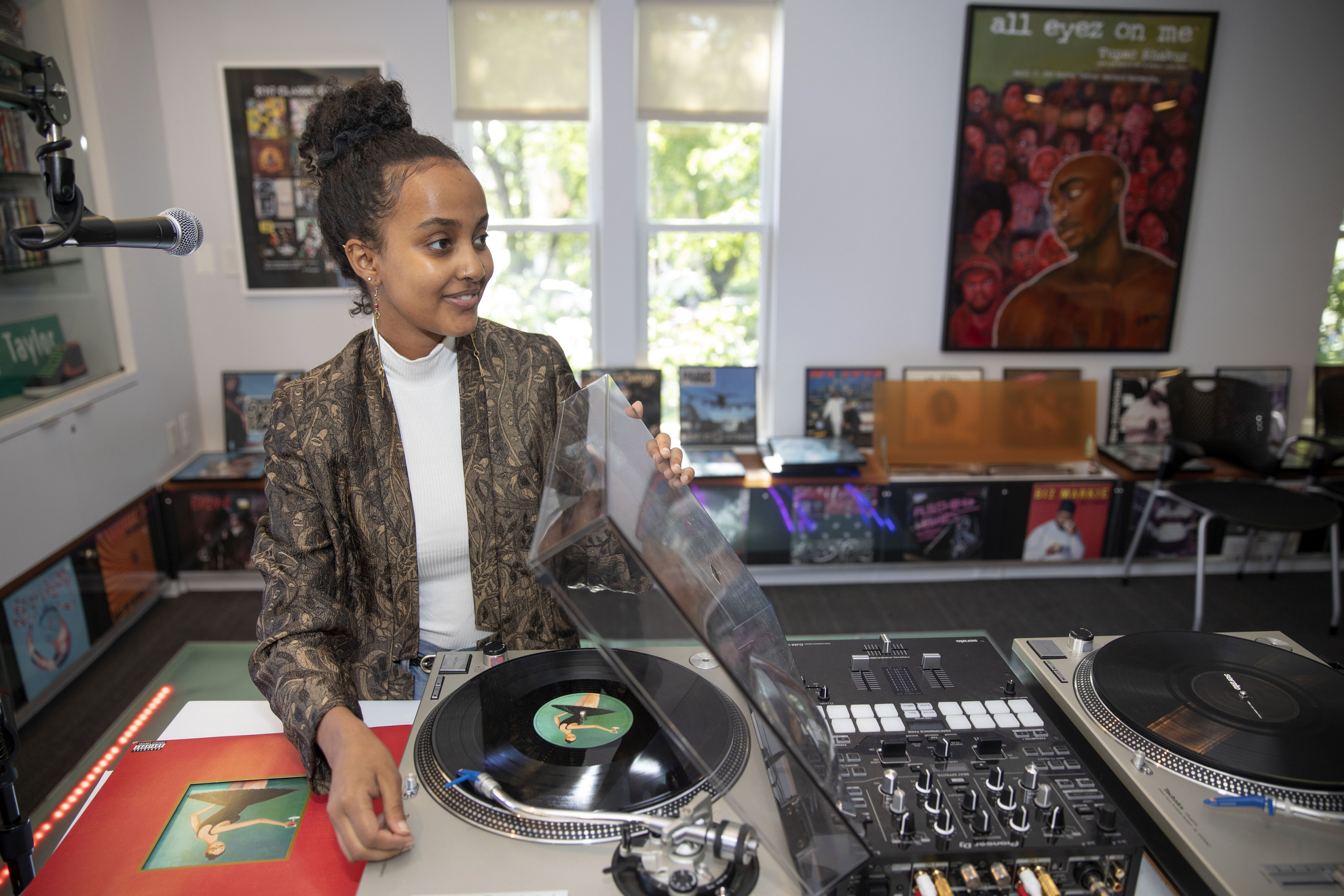 Within the Hiphop Archive and Research Institute, Makeda Daniel plays a Kanye West record on a turntable.