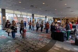 A sea of attendees navigate the hallways at a literature conference.