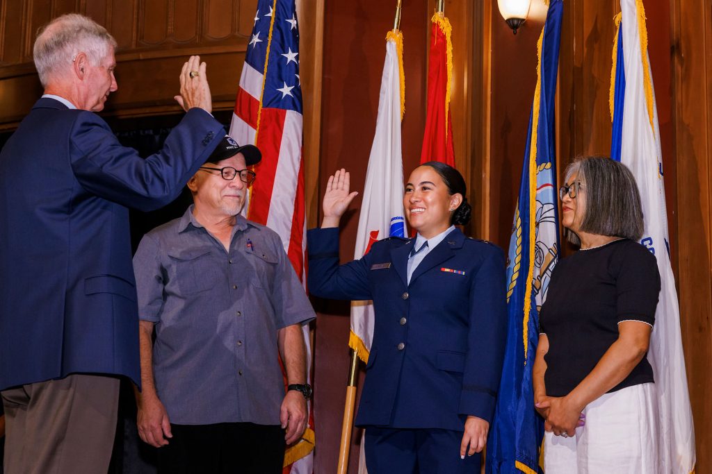 A military pinning ceremony was conducted prior to Saturday’s commencement, with College of Medicine Dean Emeritus, Dr. John P. Fogarty, presiding. Erika Balazs is sworn in by Dr. Fogarty as her parents, George and Nelia Balazs look on.