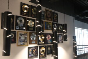 A closeup of a wall adorned with framed music records.