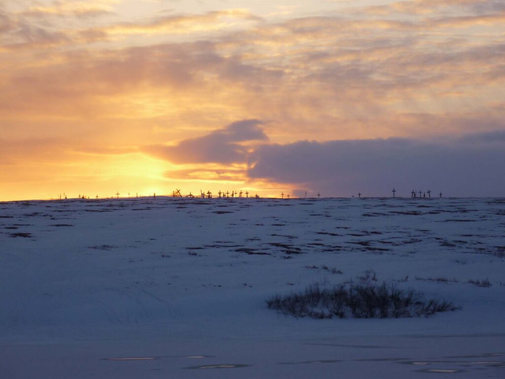 A burial ground on a hillside during sunset in a secluded Alaskan locality. Images courtesy: Lisa Wexler