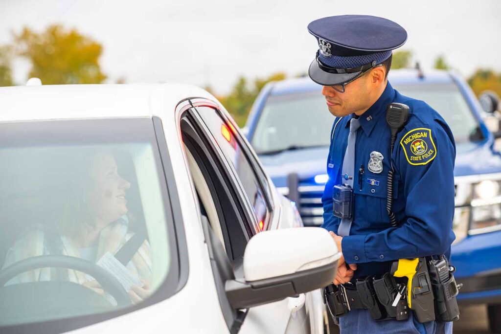A Michigan State Police officer converses with a citizen during a traffic stop. Image credit: Michigan State Police