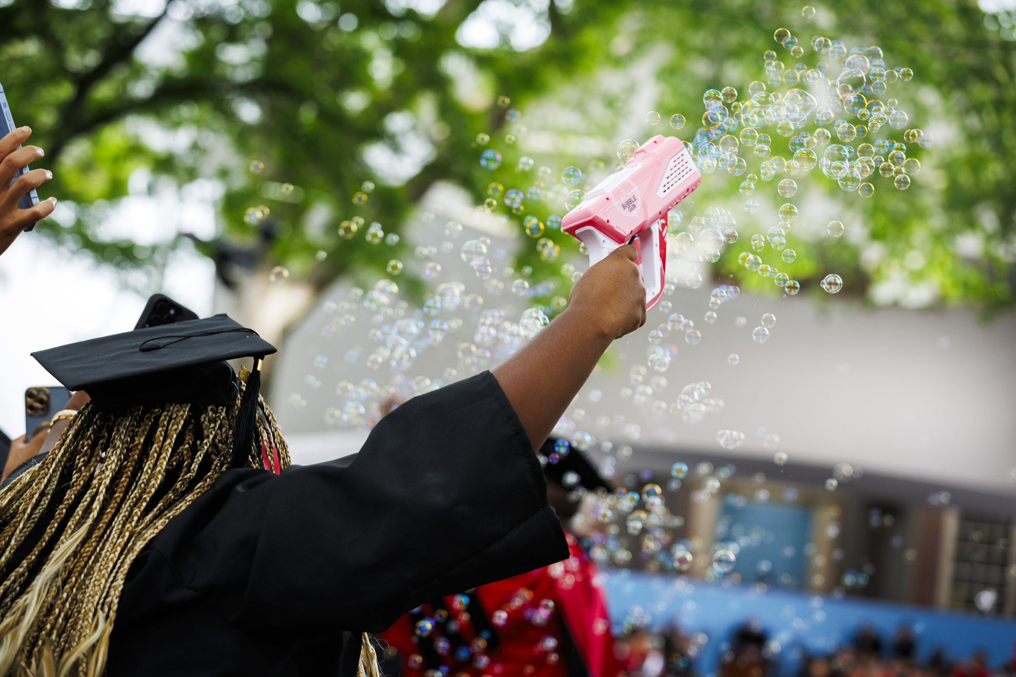 Tiffany Onyeiwu (shown) creates bubbles during the ceremony.