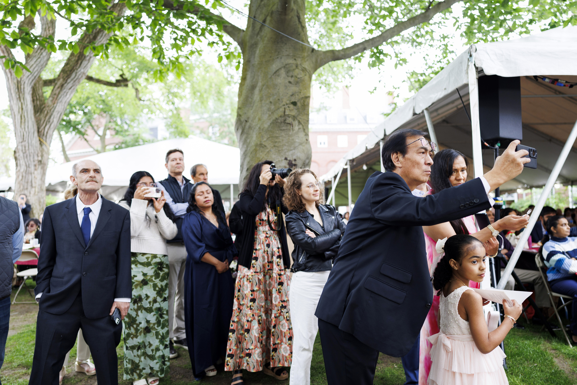 Family members observe the ceremony.