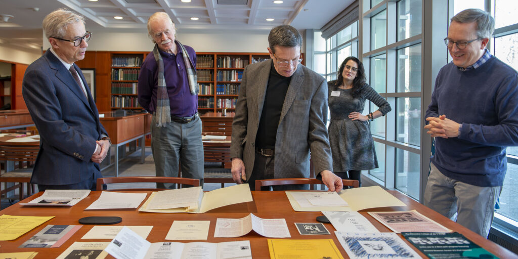 Howard Coale (center), son of Joan Coale and donor of his mother's long-term correspondence with Howard Nemerov, organizes the collection at Olin Library alongside (from left) Alex Nemerov, Howard's son; Vincent Sherry, the Howard Nemerov Professor in the Humanities in Arts & Sciences; and Joel Minor, curator of the Modern Literature Collection and Manuscripts.