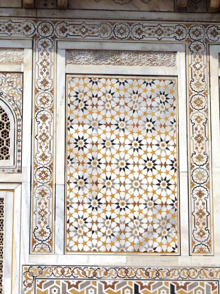 Although the symmetry of quasicrystals prevents sequential designs, their atoms still create recurring motifs reminiscent of traditional Islamic tile art. This panel on the Tomb of I'timād-ud-Daulah in Agra, India exemplifies such repetition—each distinct building block doesn't follow a consistent order left to right or up and down, yet the ten-pointed star motif recurs throughout the panel. Image credit: Anupamg, CC BY-SA 4.0, via Wikimedia Commons