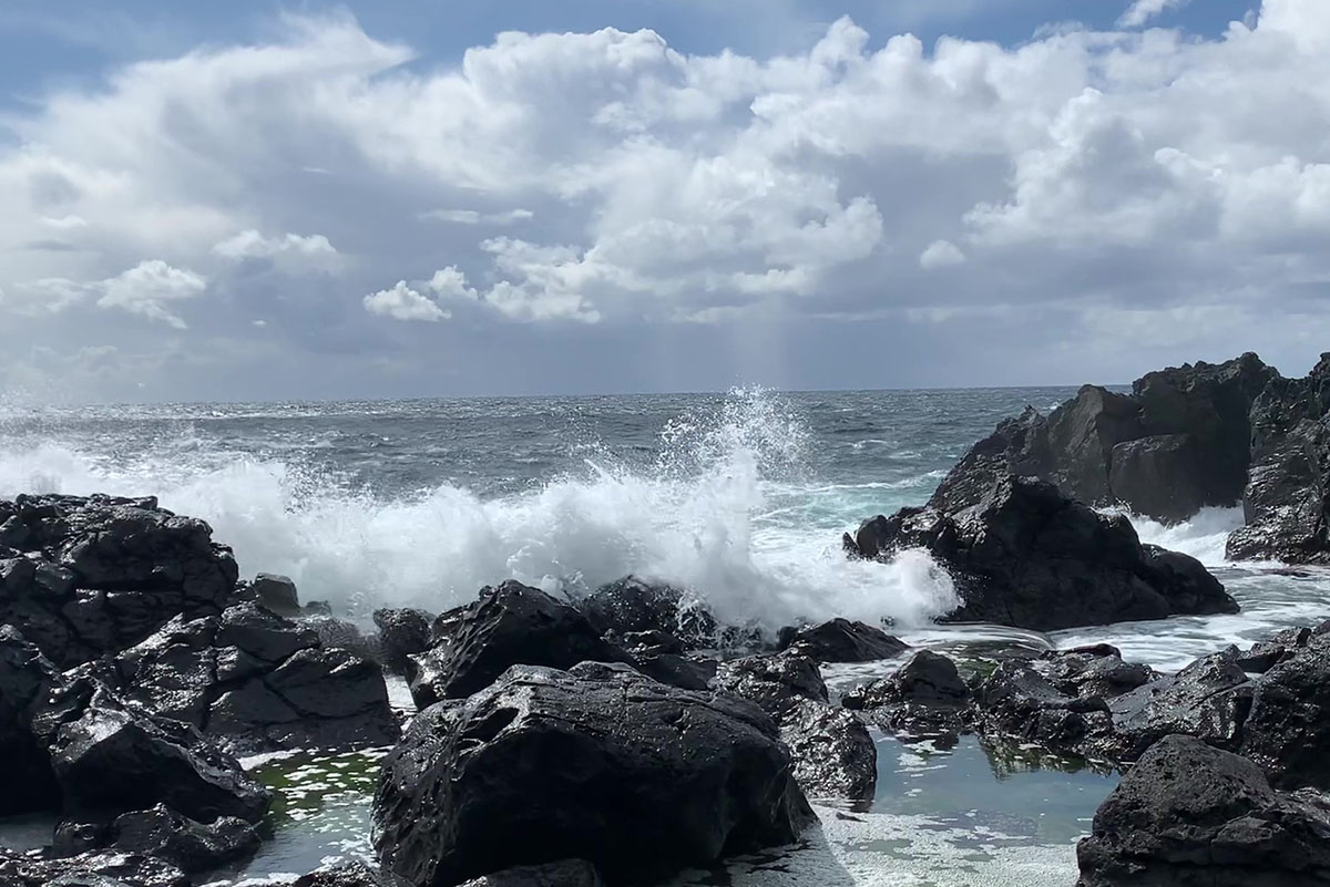 As Waves Embrace the Shore, Sea Spray Dances to Life