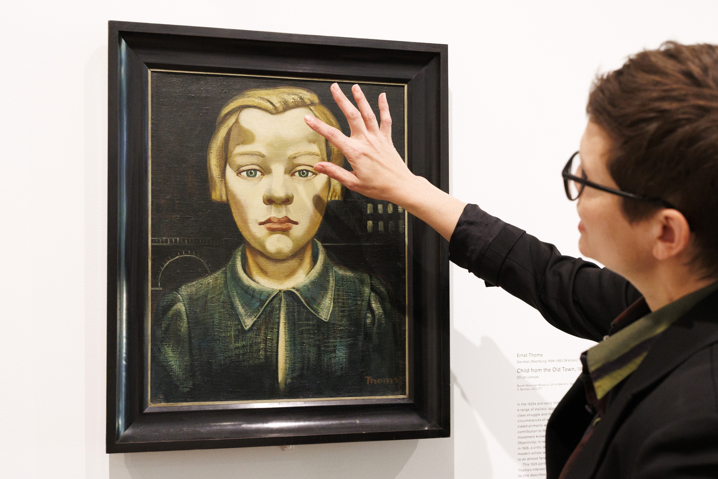 Lynette Roth, Daimler Curator of the Busch-Reisinger Museum, discusses a detail found in an object at the Harvard Art Museums at Harvard University. She is shown in front of Child from the Old Town by Ernst Thoms.