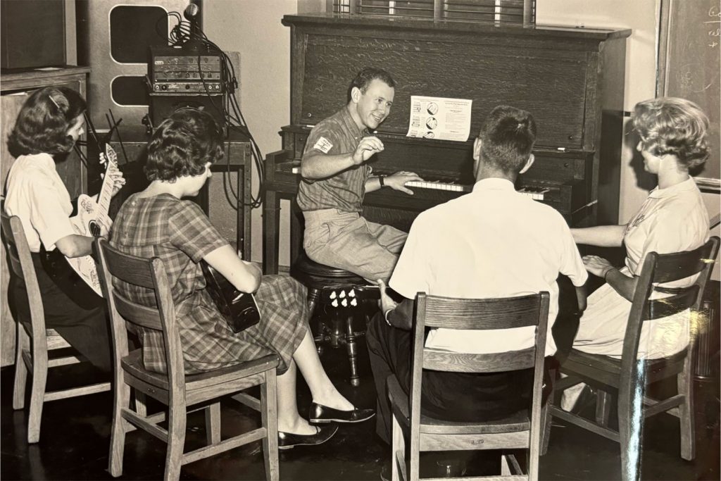 This image shows a cohort of Music Therapy students attending a classroom lecture delivered by a peer. (FSU College of Music Archives)