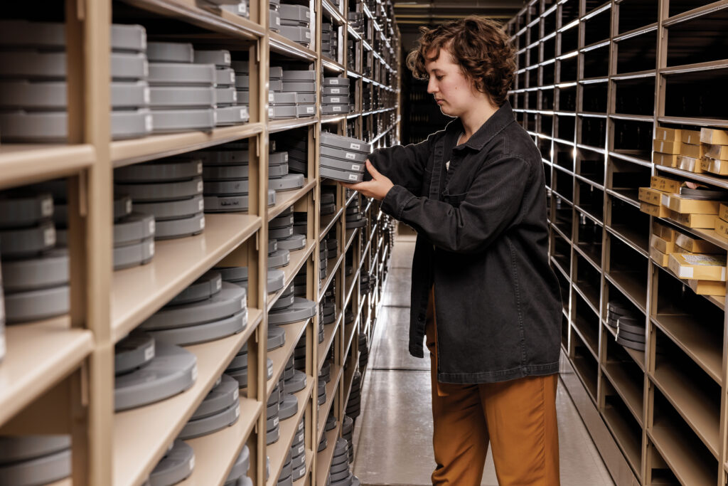 Lydia Creech, a project film preservationist, is among those engaged in the Film & Media Archive on cataloging and preserving media assets, which include 3,500 cans of film, over 11,000 videotapes, and more than 2,000 audio recordings. (Photo: Whitney Curtis/WashU)
