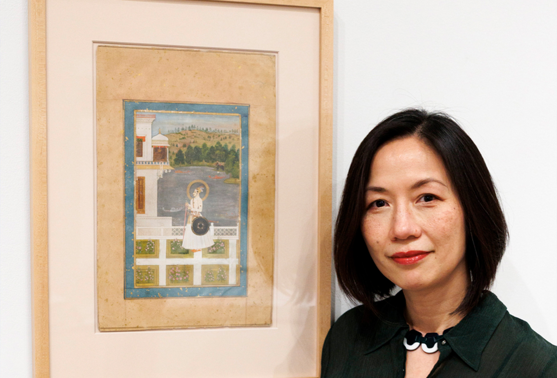 Janet O'Brien poses with a painting.