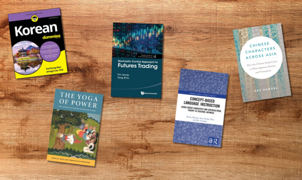Five book covers on a wooden table background
