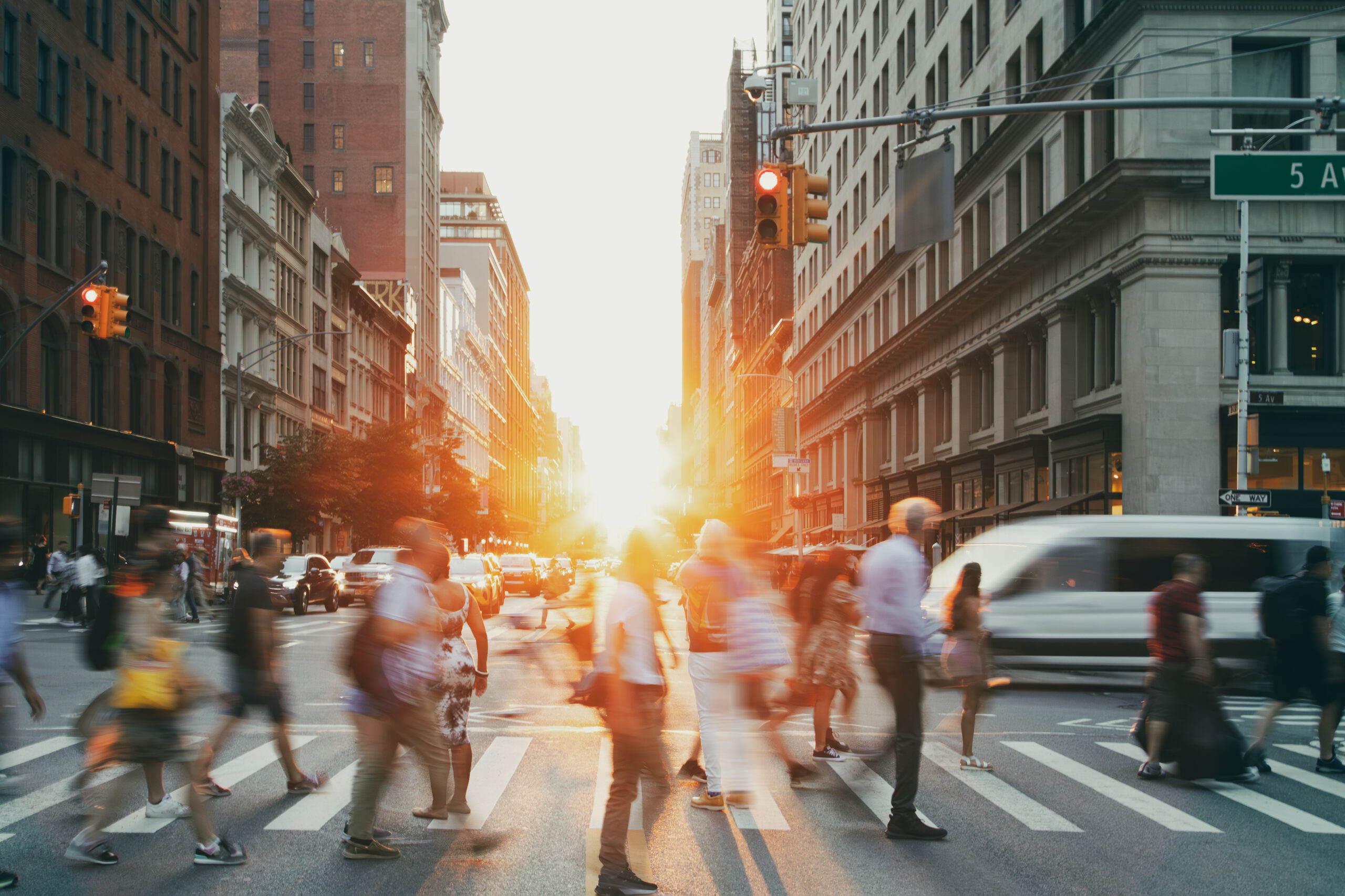 Individuals traverse a crosswalk in New York.
