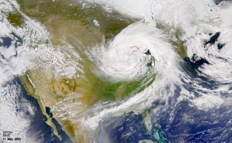 Satellite depiction of the US illustrating a low pressure weather system hovering over the midwest and extending eastward, showcasing the simulations the model produces.