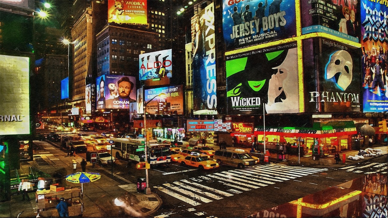 An image of Times Square at night showcasing Broadway musical advertisements, including Wicked.