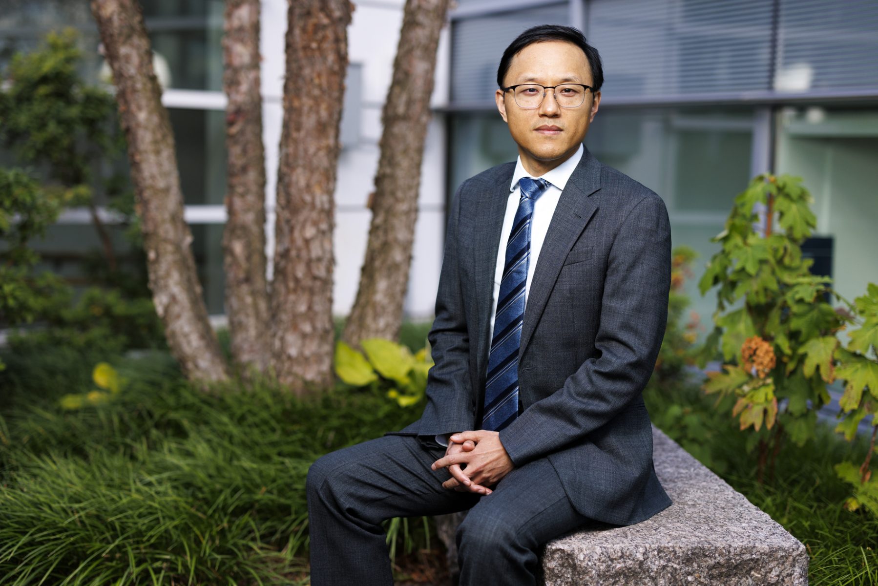 Wei Zhang seated outdoors.