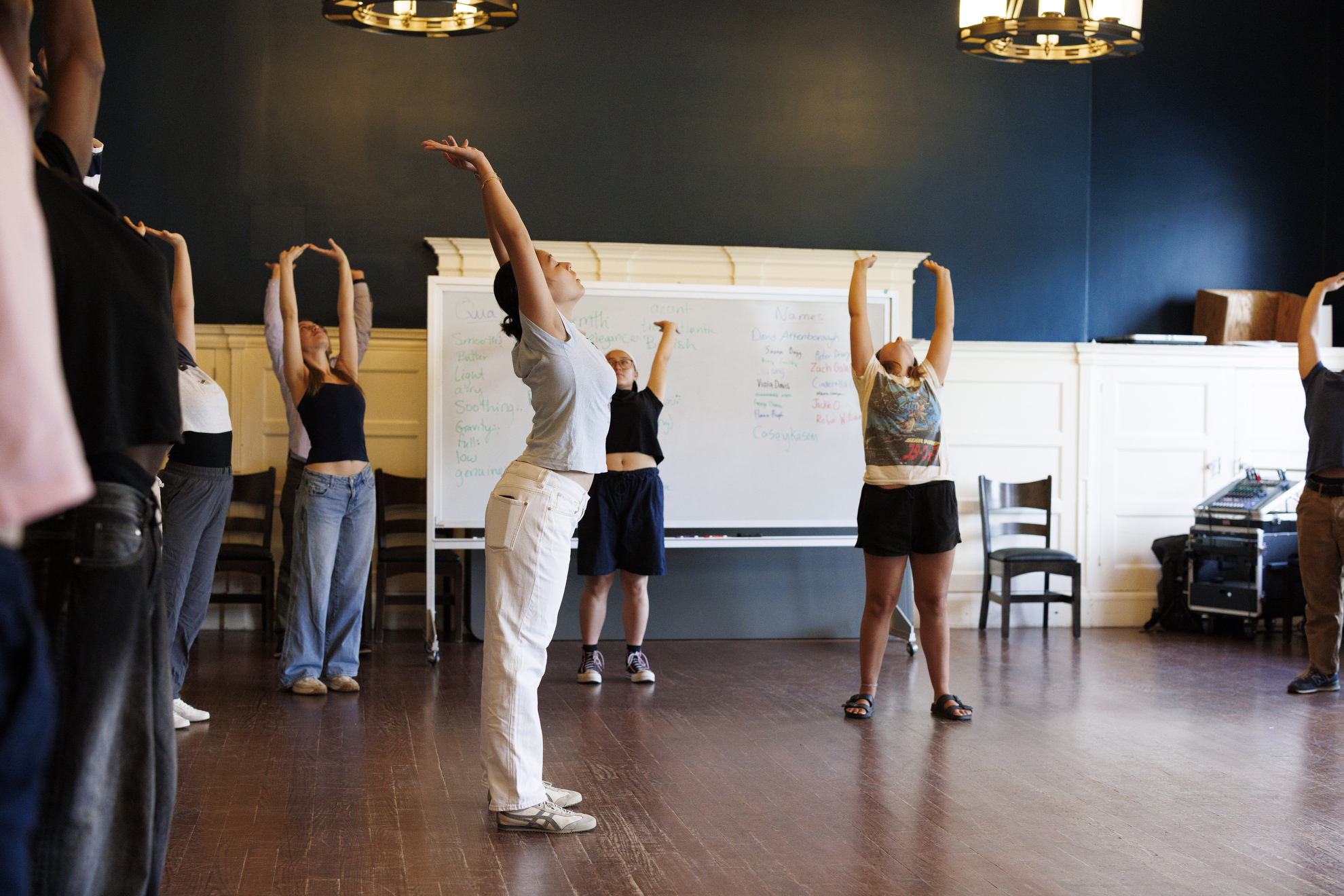 Learners execute physical movements in TDM 119: Introduction to Voice and Speech, within Farkas Hall.