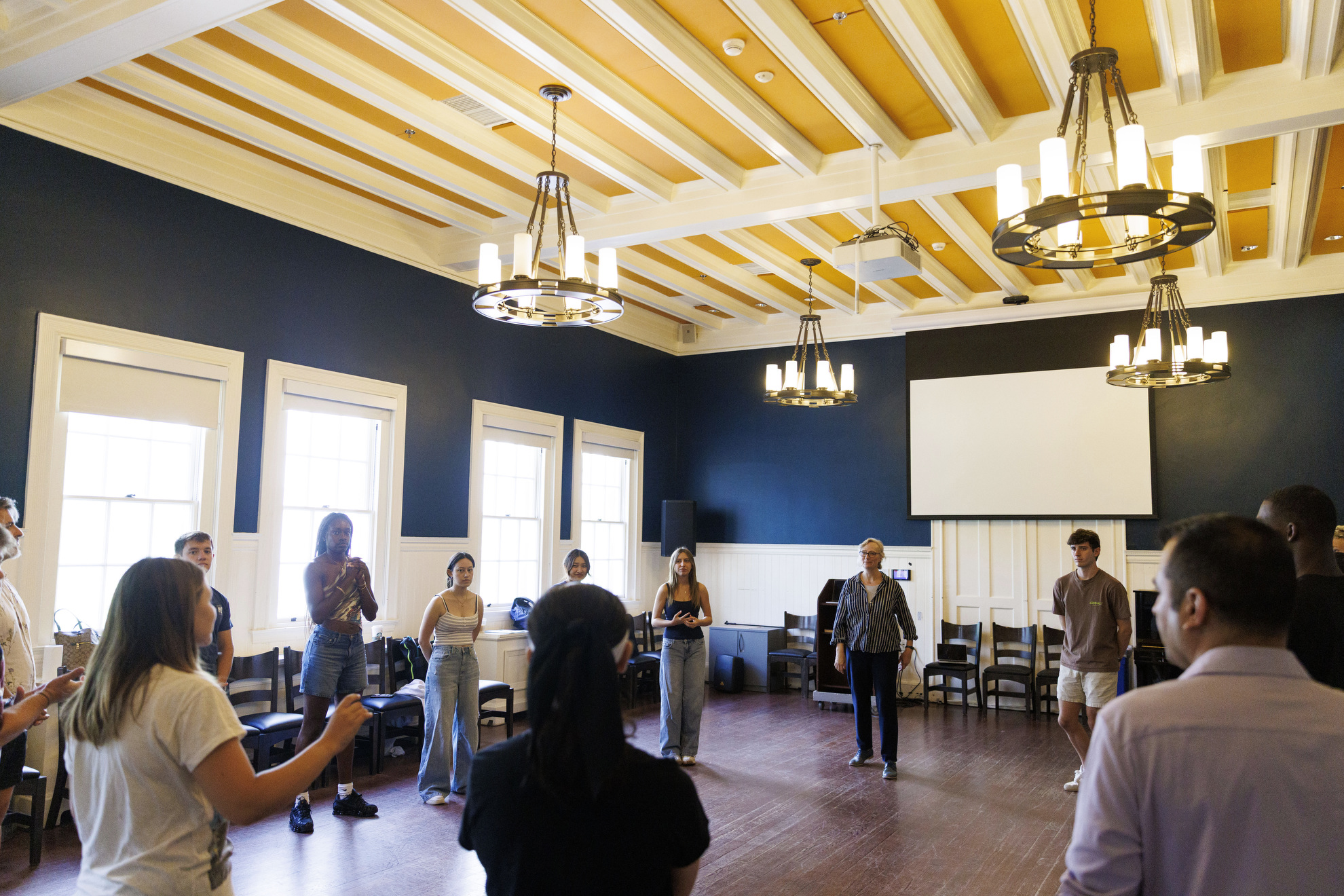 Learners in TDM 119: Overview of Voice and Speech, pay attention during an exercise in Farkas Hall.