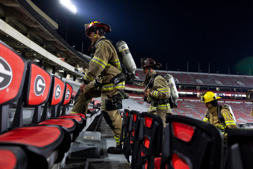 Jacob Jones, left, captain of the Athens Clarke County Fire Department directs firefighters during the 9/11 memorial stair climb.