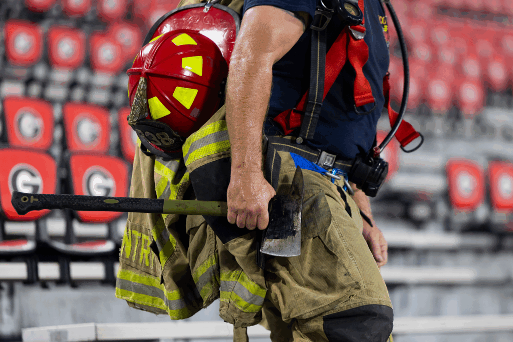Oconee County firefighter Joseph Gentry carries an axe along with his equipment.