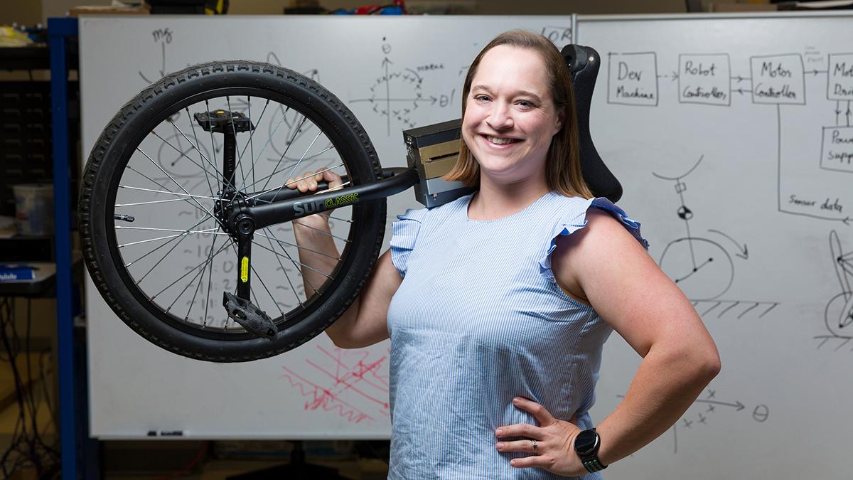 FAMU-FSU College of Engineering Assistant Professor Taylor Higgins poses with her unicycle. Higgins received a National Science Foundation Mind, Machine, and Motor Nexus (M3X) grant to further understanding of human motor learning and its applications in movement-assistive robotic technologies. (Scott Holstein/FAMU-FSU College of Engineering)