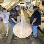 A narrative pole being sculpted in a workshop