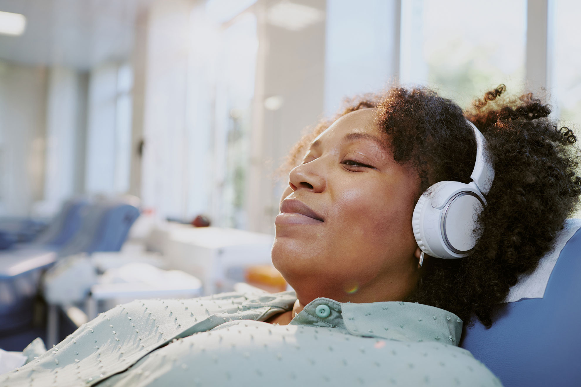 Female enjoying music while awaiting medical care.