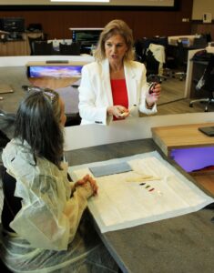 Professor Deborah Lee prepares materials for the hands-on activity at the participants’ table. Image credit: Juan Ochoa