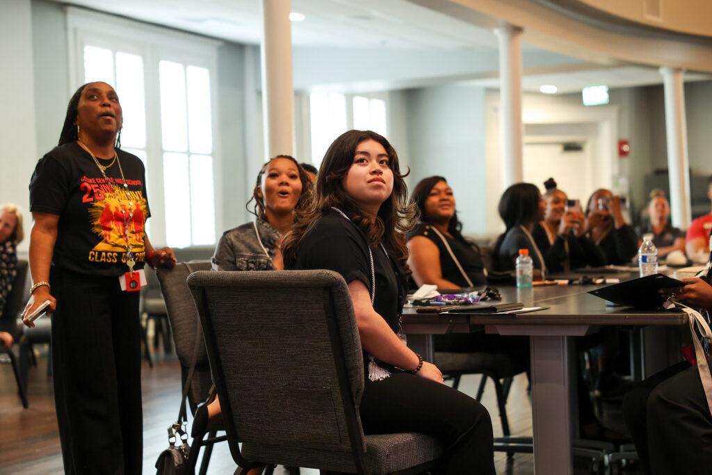 Participants listening during a presentation in a bright, contemporary room.