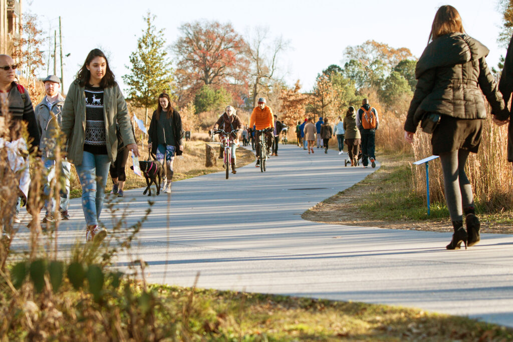 Individuals walk, run, and cycle along the Atlanta Beltline recreational area in the Old Fourth Ward in Atlanta, Georgia.